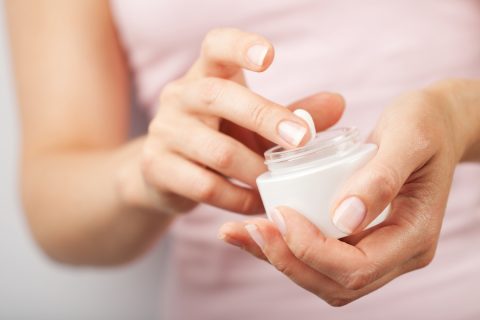 beautiful woman hands with cream;